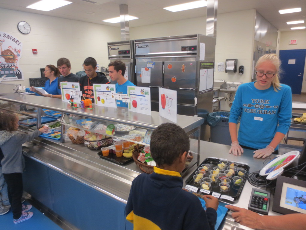 York Suburban High School Cross-country athletes (from left) Quentin Schorr, Donovan Mears, Jon Abel, and Emma Leik serve lunch at Yorkshire Elementary School.
