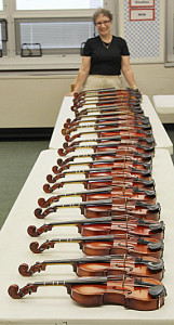 York Suburban parent Mindy Jo Hamme is shown with some of the new instruments purchased through her fund raising efforts.