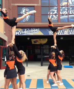 Pictured left to right, Ashleigh Mackin, Gabrielle Leiphart, Kayla Harrison, Shannon Moats, Natasha Green, Shelby Dorf, Autumn Hammel, and Madison Elliot perform their stunts in front of the Sovereign Bank Stadium. Photo Submitted by Gabrielle Leiphart.