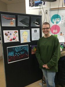 Lillian Ryder, Painting I student, displays her work from the first semester. She is most proud of her self-portrait.